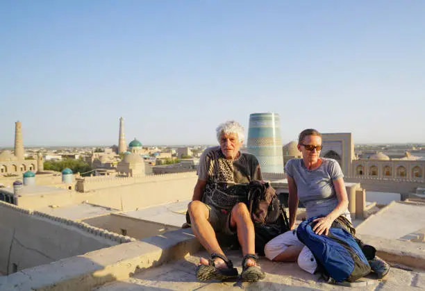 Photo of Tourists, seniors, posing for photo on the top of the Ancient city’s old town of Khiva in Uzbekistan