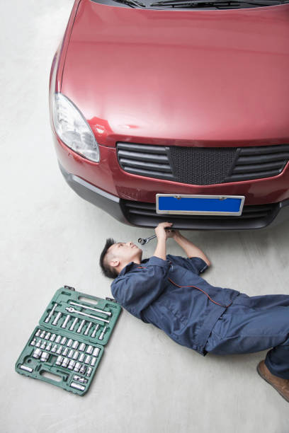 Chinese mechanic working in garage
