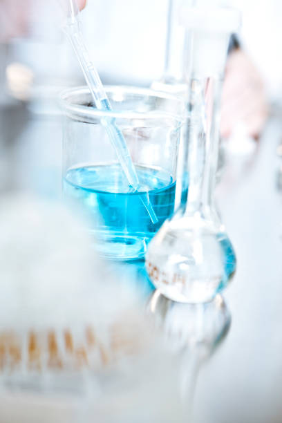 Close-up of blue solution in beaker at laboratory Close-up of blue solution in beaker. Laboratory glassware on table. It is in biochemistry industry. pharmaceutical factory photos stock pictures, royalty-free photos & images