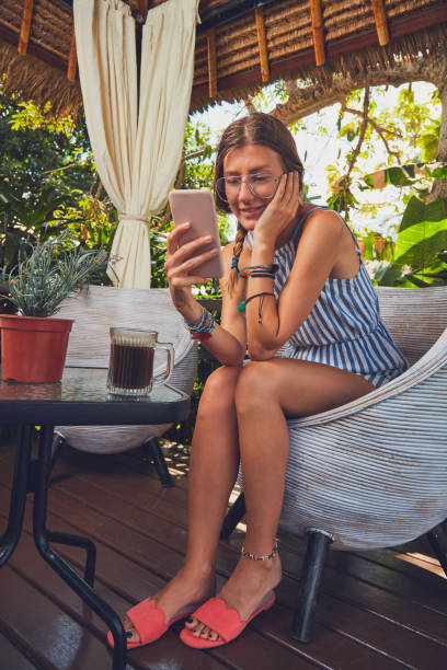 istock Cute girl with eyeglasses using cellphone  on a terrace. 1089650334
