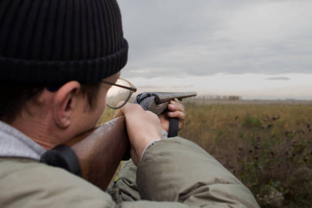 istock Hunter With Old Hunting Riffle Waiting for Pray in the Woods 1089655336