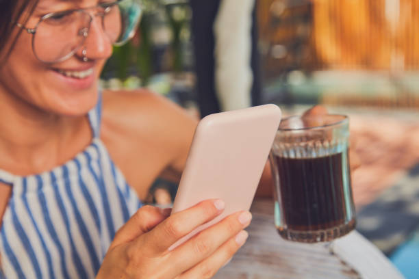 istock Cute girl with eyeglasses using cellphone  on a terrace. 1089660566