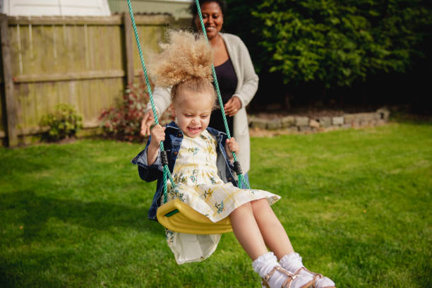 istock Mother Pushing Daugher on a Swing 1089660798