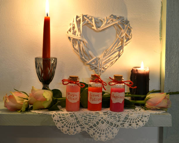 istock Cute bottles with happiness, love potion, magic elixir and roses in candlelight 1089662206