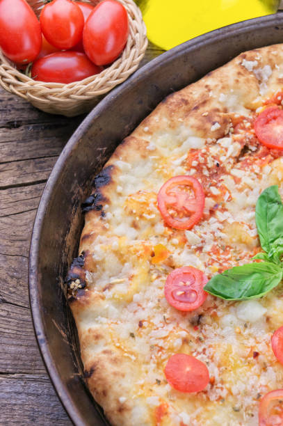 istock Homemade pizza on wooden background 1089662314