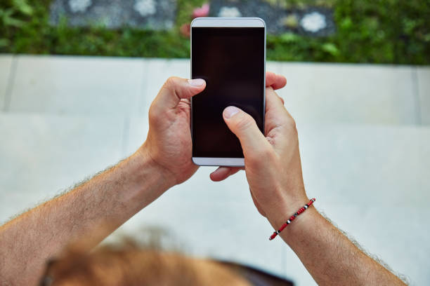 istock Man using cellphone on the porch in front of a house. 1089662708