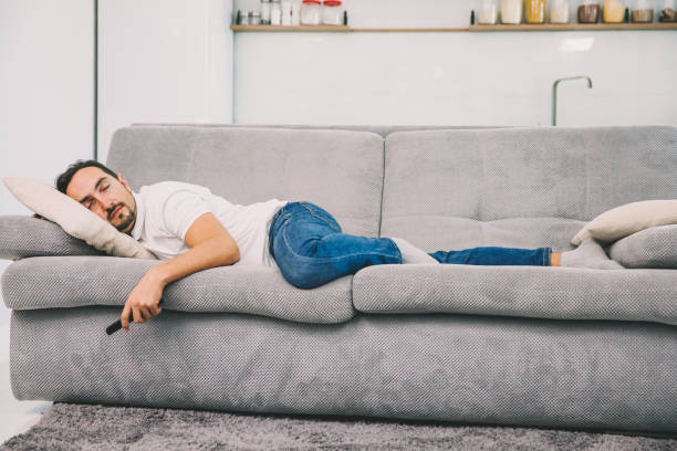 istock The man fell asleep on the couch holding the remote 1089663166