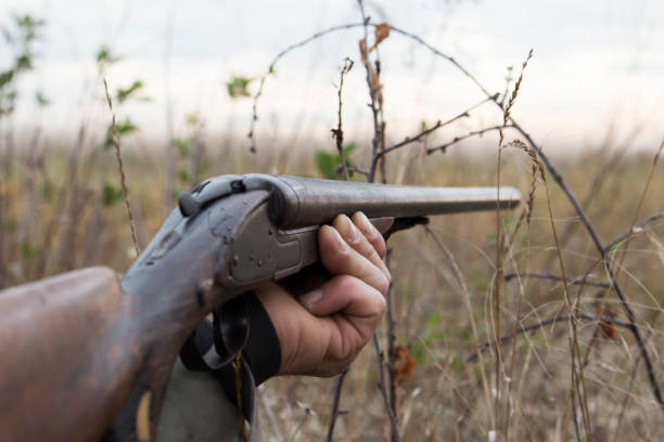 istock Hunter With Old Hunting Riffle Waiting for Pray in the Woods 1089663888