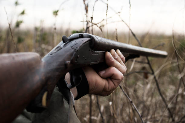 istock Hunter With Old Hunting Riffle Waiting for Pray in the Woods 1089665434