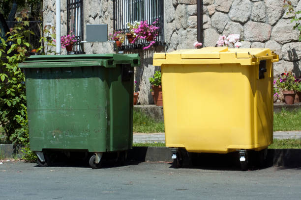 Green and yellow garbage bins for recycling seen in a city street, sunny day. Galicia, Spain.