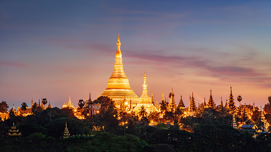 Panorama of beautiful sunset over the famous Shwedagon Pagoda during sunset. Aerial skyline cityscape view from above. Yangong, Myanmar, Burma, Asia.