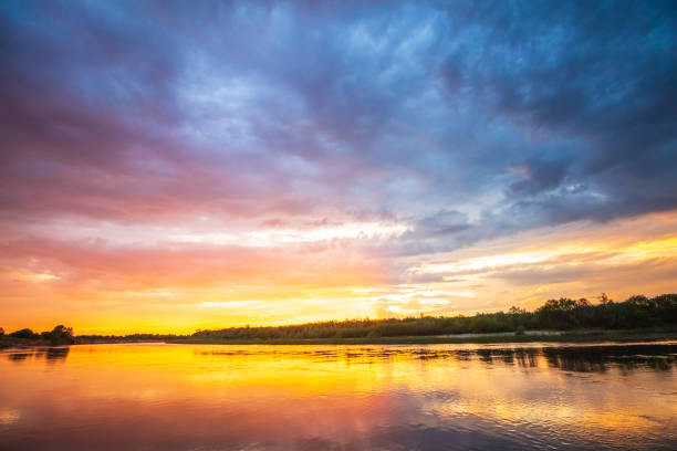 istock Fiery sunset on the river with reflection in the water 1089676470