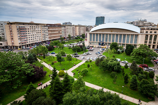 Color image depicting an aerial view of a lush green park and surrounding communist architecture in central Bucharest, Romania. Room for copy space.