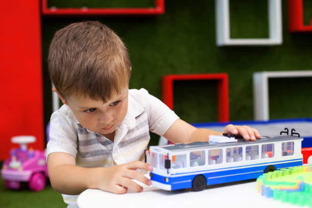 istock Cute boy playing with trolley car. Developing toys. 1089682848