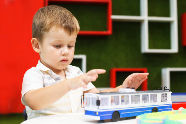 istock Cute boy playing with trolley car. Developing toys. 1089682850