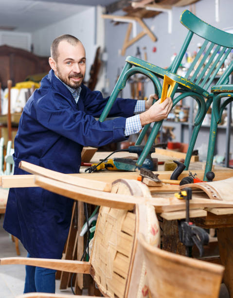istock Carpenter repairing antique chair 1089688850