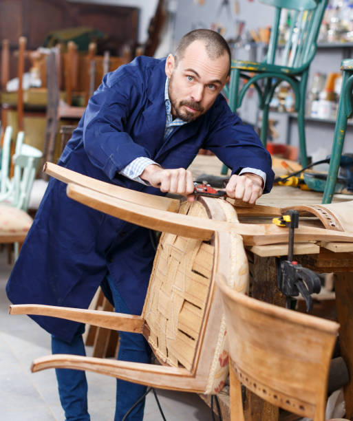 istock Carpenter repairing antique chair 1089688868