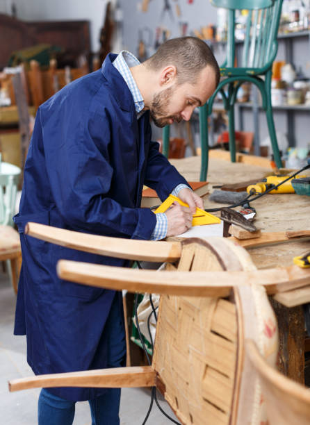 istock Carpenter repairing antique chair 1089688888