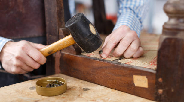 istock Man upholstering antique chair, close up 1089688924