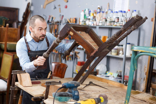 istock Artisan inspecting old chair 1089689014