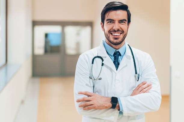 istock Smiling doctor standing in the hospital corridor 1089689620