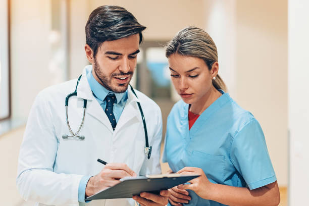 istock Doctor and nurse looking in a clipboard 1089689624