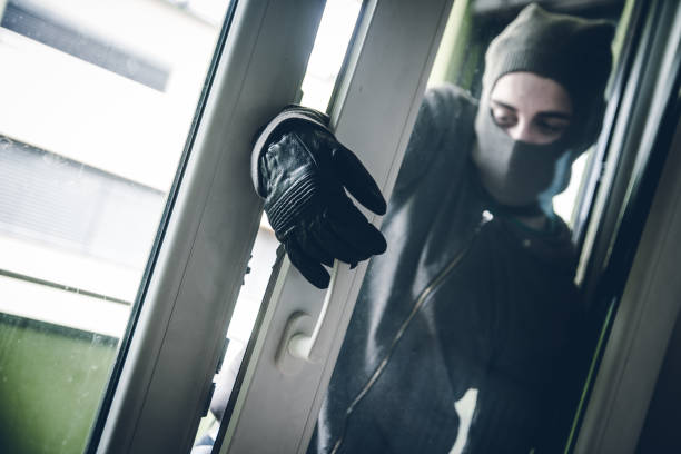 istock Burglar Breaking Into House 1089691952