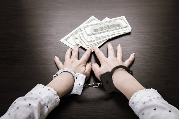 istock handcuffed hands and paper money 1089692244