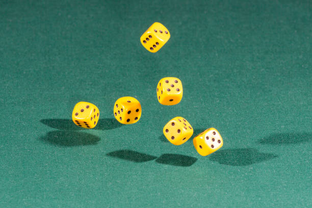 istock Six yellow dices falling on a green table 1089692594