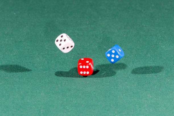 istock White, red and blue dices falling on a green table 1089693404