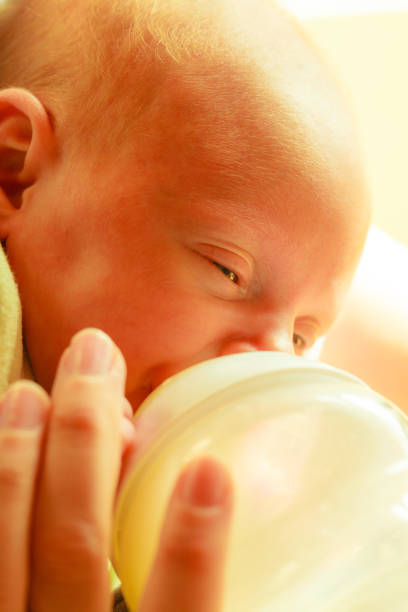 istock Little newborn eating drinking from bottle 1089694842