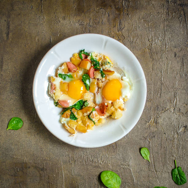 istock Fried eggs with spinach, sausage and breadcrumbs - healthy breakfast (quick meal). Top view. copy space 1089695338