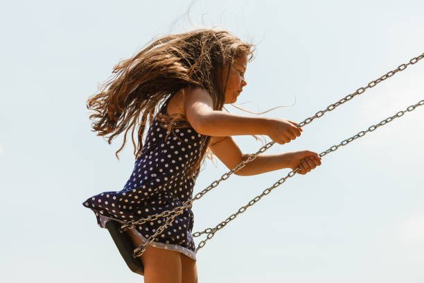istock Girl swinging on swing-set. 1089695348