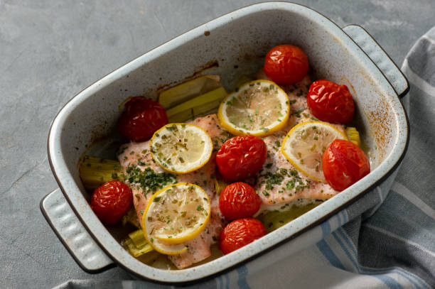 istock Oven baked salmon with leek and tomatoes. 1089696212