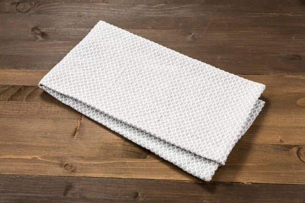 istock White tablecloth isolated on wooden background 1089698868