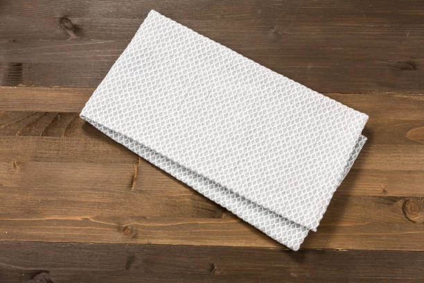 istock White tablecloth isolated on wooden background 1089698946