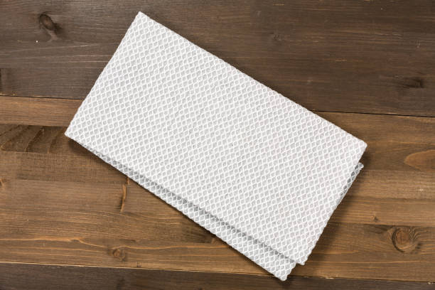 istock White tablecloth isolated on wooden background 1089698980