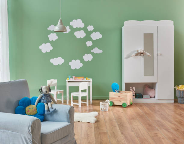 Child room interior decoration Decorative baby room interior concept, grey wall and cloudy pattern on the wall, wardrobe and armchair in the room, toys for child. newborn horse stock pictures, royalty-free photos & images