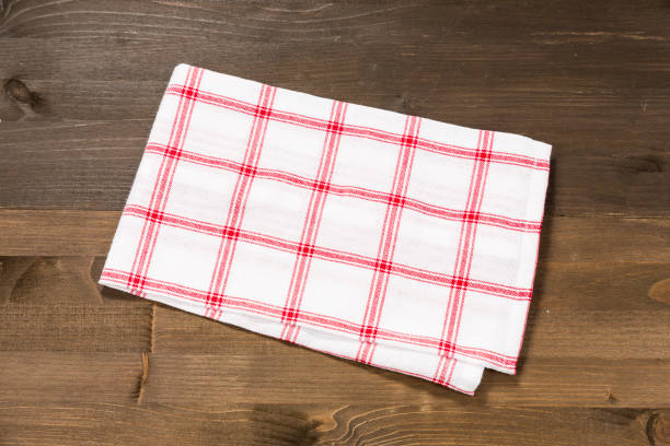 istock Checkered tablecloth isolated on wooden background 1089700540