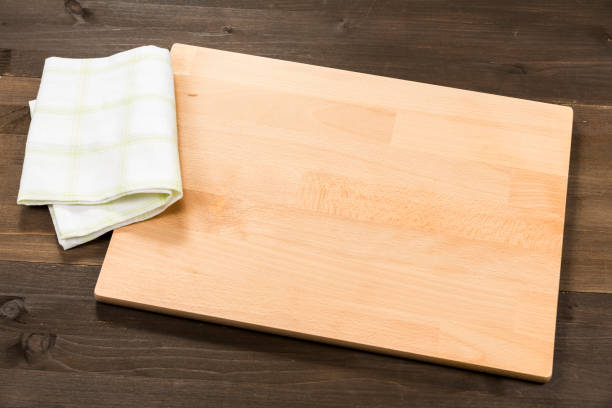 istock Cutting board and checkered tablecloth isolated on wooden background 1089700700