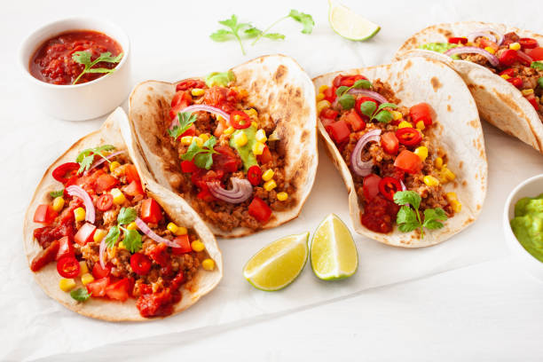 istock mexican beef and pork tacos with salsa, guacamole and vegetables 1089703016