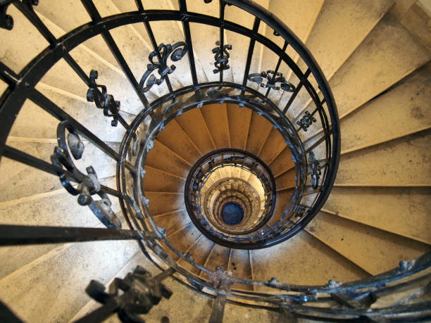 istock Spiral staircase in an old house with iron railings 1089703136