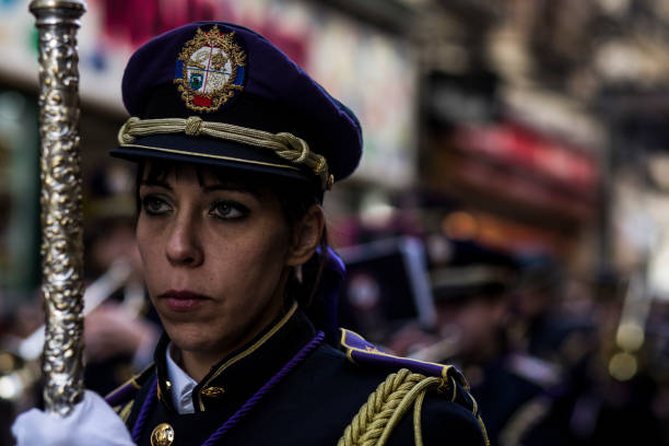 A group of uniformed musicians performing in a Sicilian processione in Trapani, Italy. The brass band fills the streets with rhythm as crowds gather for Good Friday’s traditional procession and cultural spectacle.