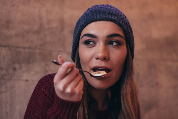 istock Beautiful woman eats healthy breakfast 1089703892