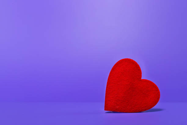 istock Heart on purple background. Free space on the left 1089706052