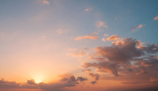 istock sunset sky  background - sun behind colorful clouds 1089707340