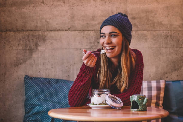 istock Girl with hat enjoys healthy breakfast 1089712158