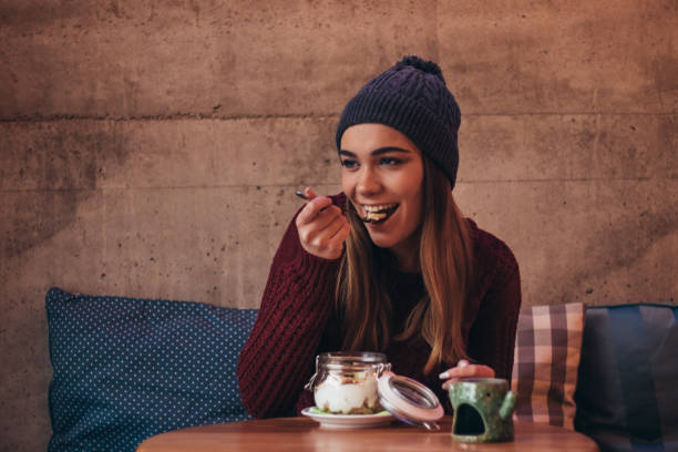 istock Happy woman eats healthy breakfast at cafe 1089712774
