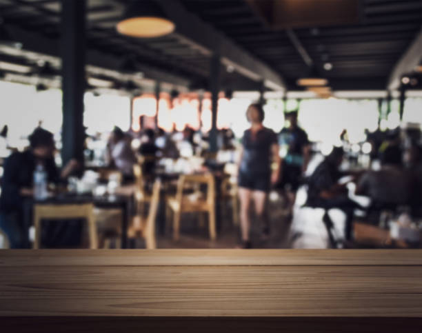 istock Emty wooden bar table with blurred people in the restaurant. 1089715010