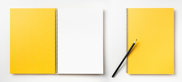Design concept - Top view of  red spiral notebook front, back, white page and pencil isolated on background for mockup